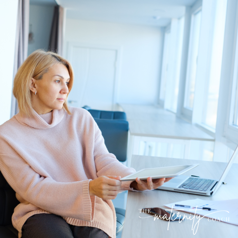 Woman sitting at desk looking out of a window