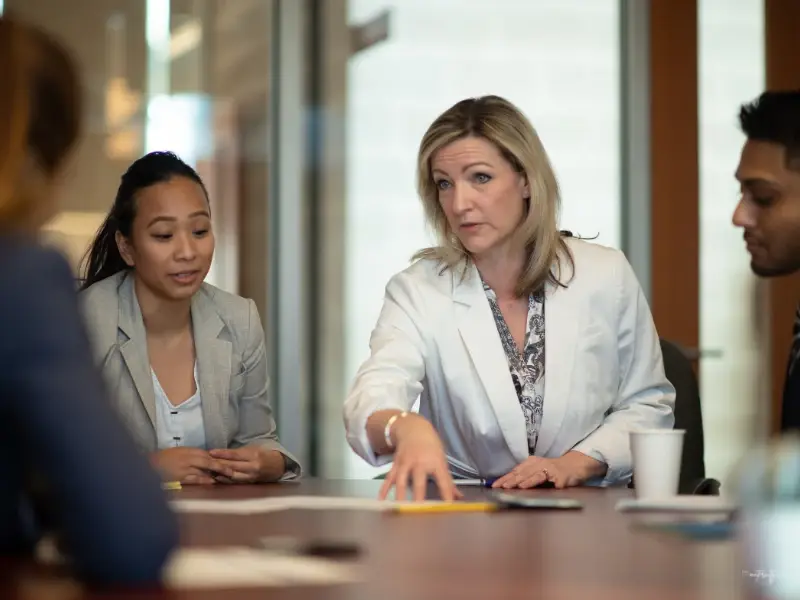 Woman talking in a meeting at an organisation supported by the Maternity Coach